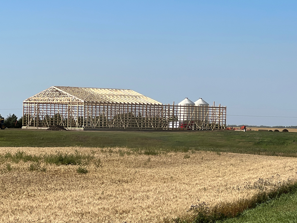 Pole barn frame in a field