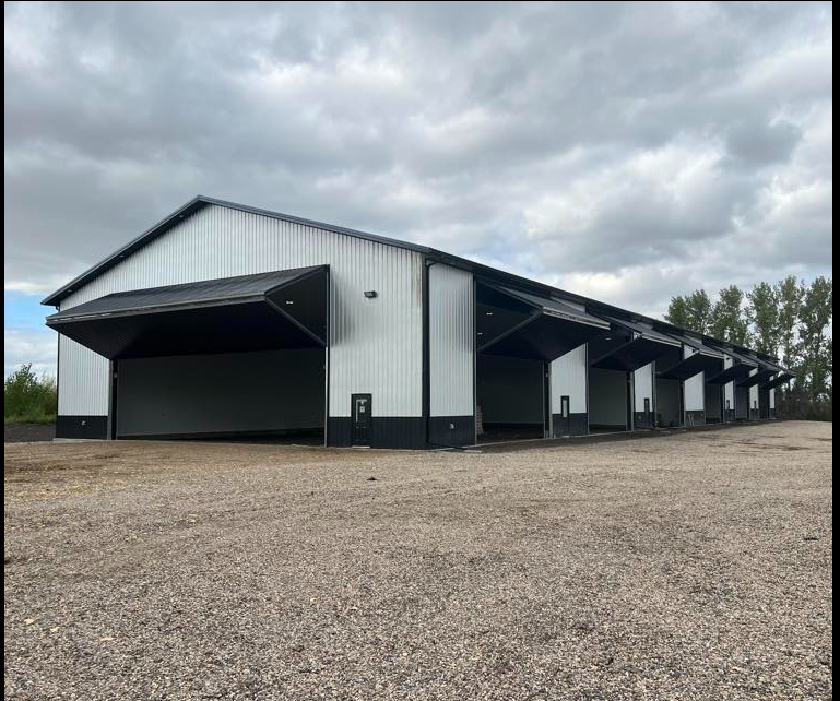 Large white shop with overhead doors